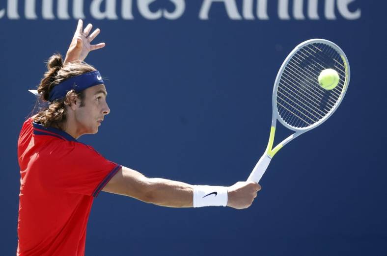 Sep 2, 2021; Flushing, NY, USA; Lorenzo Musetti of Italy hits a shot against Reilly Opelka of the United States in a second round match on day four of the 2021 U.S. Open tennis tournament at USTA Billie Jean King National Tennis Center. Mandatory Credit: Jerry Lai-USA TODAY Sports