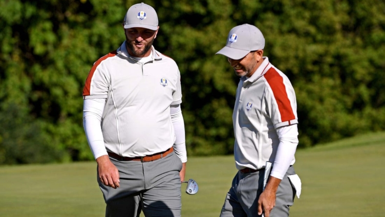 Sep 25, 2021; Haven, Wisconsin, USA; Team Europe player Jon Rahm and Team Europe player Rory McIlroy react on the ninth green during day two four-ball rounds for the 43rd Ryder Cup golf competition at Whistling Straits. Mandatory Credit: Orlando Ramirez-USA TODAY Sports