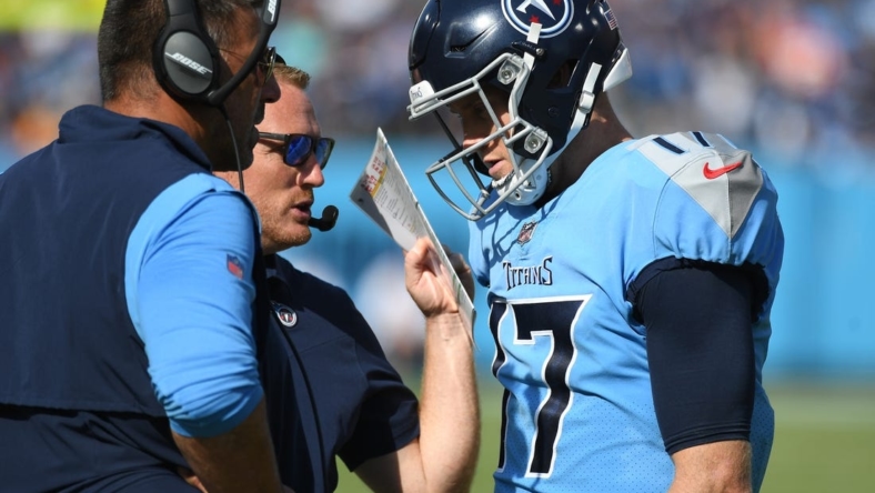 Oct 24, 2021; Nashville, Tennessee, USA; Tennessee Titans quarterback Ryan Tannehill (17) talks with Tennessee Titans head coach Mike Vrabel and Tennessee Titans offensive coordinator Todd Downing during the second half against the Kansas City Chiefs at Nissan Stadium. Mandatory Credit: Christopher Hanewinckel-USA TODAY Sports