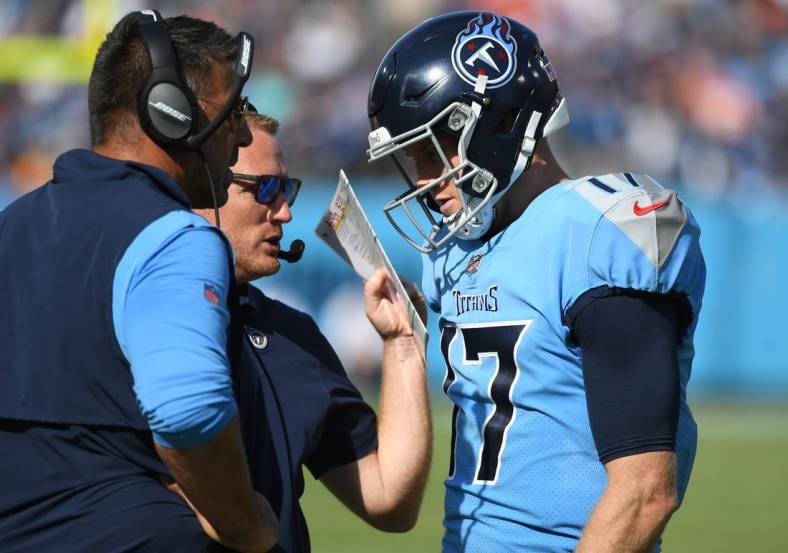 Oct 24, 2021; Nashville, Tennessee, USA; Tennessee Titans quarterback Ryan Tannehill (17) talks with Tennessee Titans head coach Mike Vrabel and Tennessee Titans offensive coordinator Todd Downing during the second half against the Kansas City Chiefs at Nissan Stadium. Mandatory Credit: Christopher Hanewinckel-USA TODAY Sports