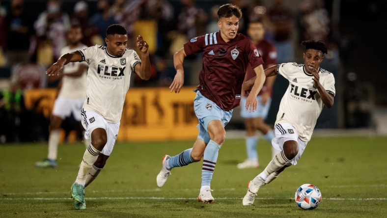 Nov 7, 2021; Commerce City, Colorado, USA; Colorado Rapids midfielder Cole Bassett (26) controls the ball under pressure from Los Angeles FC defender Diego Palacios (12) and forward Latif Blessing (7) in the second half at Dick's Sporting Goods Park. Mandatory Credit: Isaiah J. Downing-USA TODAY Sports