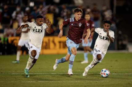 Nov 7, 2021; Commerce City, Colorado, USA; Colorado Rapids midfielder Cole Bassett (26) controls the ball under pressure from Los Angeles FC defender Diego Palacios (12) and forward Latif Blessing (7) in the second half at Dick's Sporting Goods Park. Mandatory Credit: Isaiah J. Downing-USA TODAY Sports