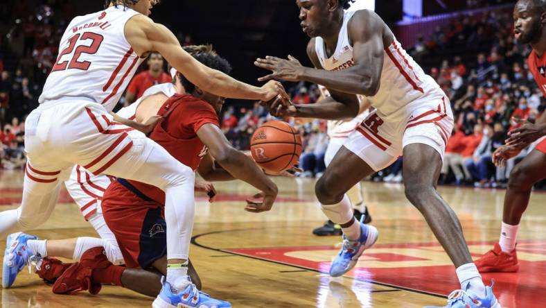 Nov 16, 2021; Piscataway, New Jersey, USA; Rutgers Scarlet Knights guard Caleb McConnell (22) and center Cliff Omoruyi (11) battles for a loose ball against NJIT Highlanders guard James Lee (1) during the first half at Jersey Mike's Arena. Mandatory Credit: Vincent Carchietta-USA TODAY Sports