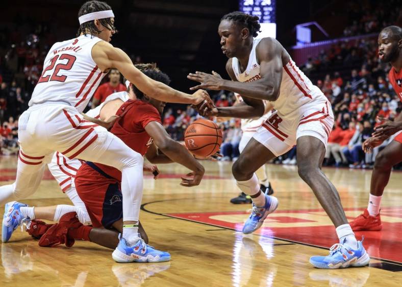 Nov 16, 2021; Piscataway, New Jersey, USA; Rutgers Scarlet Knights guard Caleb McConnell (22) and center Cliff Omoruyi (11) battles for a loose ball against NJIT Highlanders guard James Lee (1) during the first half at Jersey Mike's Arena. Mandatory Credit: Vincent Carchietta-USA TODAY Sports