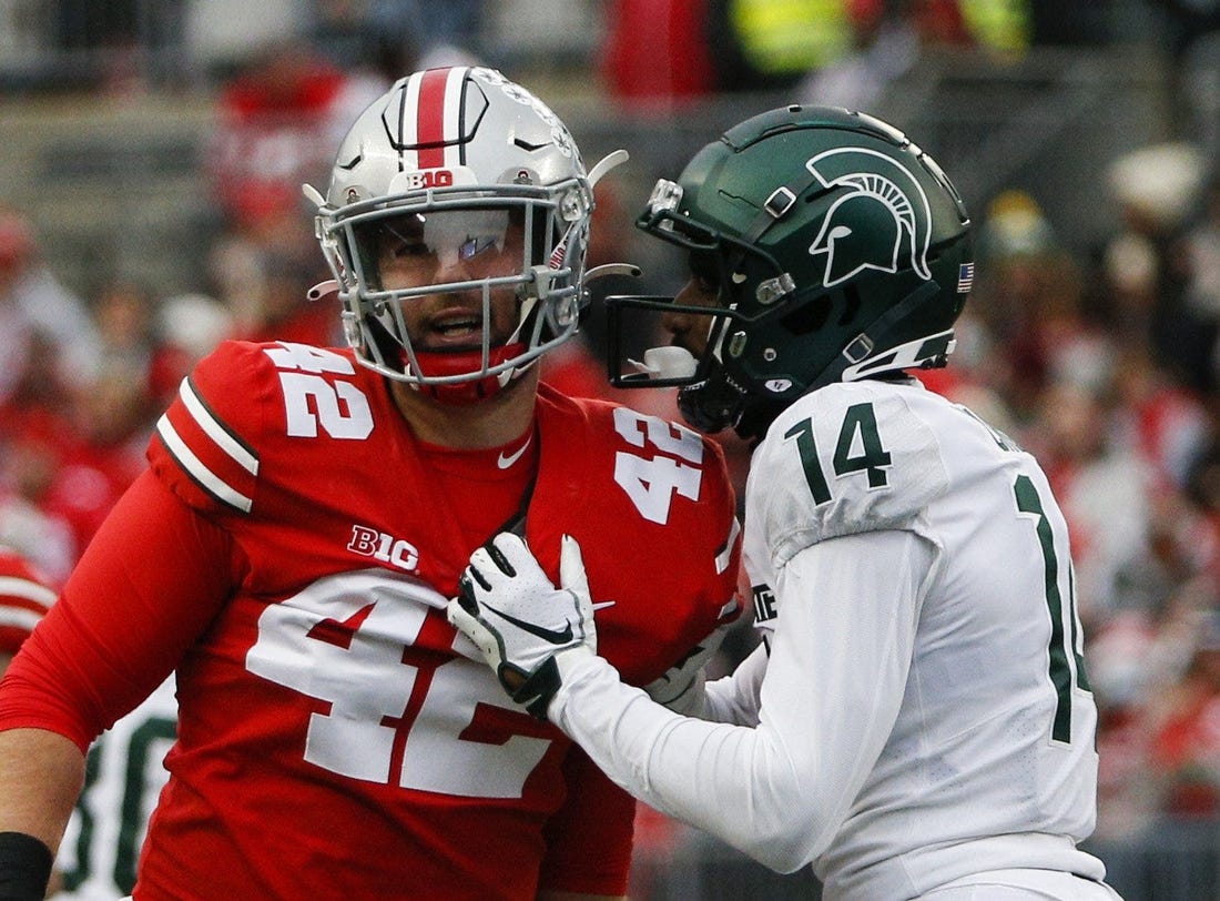 Sat., Nov. 20, 2021; Columbus, Ohio, USA; Michigan State Spartans cornerback Khary Crump (14) and Ohio State Buckeyes long snapper Bradley Robinson (42) share words after a punt return during the fourth quarter of a NCAA Division I football game between the Ohio State Buckeyes and the Michigan State Spartans at Ohio Stadium. Mandatory Credit: Joshua A. Bickel/Columbus Dispatch via USA TODAY Network.

Cfb Michigan State Spartans At Ohio State Buckeyes