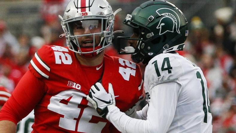 Sat., Nov. 20, 2021; Columbus, Ohio, USA; Michigan State Spartans cornerback Khary Crump (14) and Ohio State Buckeyes long snapper Bradley Robinson (42) share words after a punt return during the fourth quarter of a NCAA Division I football game between the Ohio State Buckeyes and the Michigan State Spartans at Ohio Stadium. Mandatory Credit: Joshua A. Bickel/Columbus Dispatch via USA TODAY Network.

Cfb Michigan State Spartans At Ohio State Buckeyes