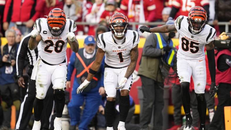 Jan 30, 2022; Kansas City, Missouri, USA; Cincinnati Bengals running back Joe Mixon (left) and wide receiver Ja'Marr Chase (center) and wide receiver Tee Higgins (85) celebrate a touchdown against the Kansas City Chiefs during the third quarter of the AFC Championship Game at GEHA Field at Arrowhead Stadium. Mandatory Credit: Jay Biggerstaff-USA TODAY Sports