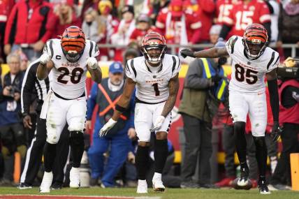 Jan 30, 2022; Kansas City, Missouri, USA; Cincinnati Bengals running back Joe Mixon (left) and wide receiver Ja'Marr Chase (center) and wide receiver Tee Higgins (85) celebrate a touchdown against the Kansas City Chiefs during the third quarter of the AFC Championship Game at GEHA Field at Arrowhead Stadium. Mandatory Credit: Jay Biggerstaff-USA TODAY Sports