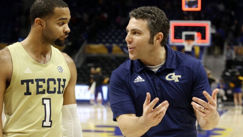 Feb 19, 2022; Pittsburgh, Pennsylvania, USA; Georgia Tech Yellow Jackets guard Kyle Sturdivant (1) and head coach Josh Pastner (right) celebrate while leaving the court after defeating the Pittsburgh Panthers at the Petersen Events Center. The Yellow Jackets won 68-62. Mandatory Credit: Charles LeClaire-USA TODAY Sports