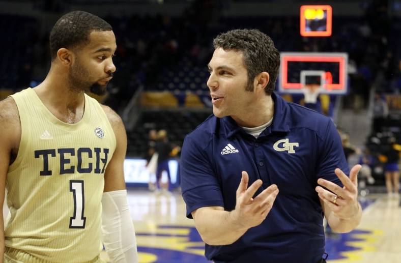 Feb 19, 2022; Pittsburgh, Pennsylvania, USA; Georgia Tech Yellow Jackets guard Kyle Sturdivant (1) and head coach Josh Pastner (right) celebrate while leaving the court after defeating the Pittsburgh Panthers at the Petersen Events Center. The Yellow Jackets won 68-62. Mandatory Credit: Charles LeClaire-USA TODAY Sports