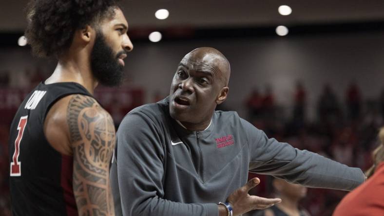 Mar 3, 2022; Houston, Texas, USA; Temple Owls head coach Aaron McKie talks to guard Damian Dunn (1) during a Houston Cougars time-out  in the first half at Fertitta Center. Mandatory Credit: Thomas Shea-USA TODAY Sports