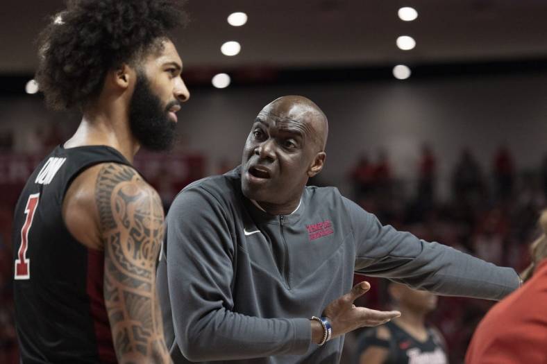 Mar 3, 2022; Houston, Texas, USA; Temple Owls head coach Aaron McKie talks to guard Damian Dunn (1) during a Houston Cougars time-out  in the first half at Fertitta Center. Mandatory Credit: Thomas Shea-USA TODAY Sports
