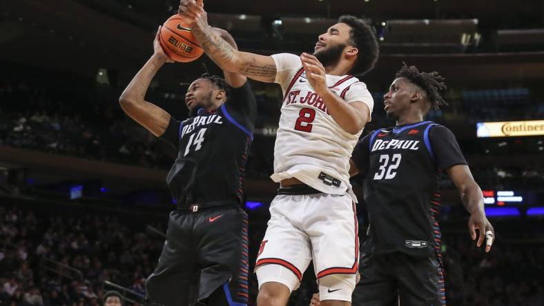 Mar 9, 2022; New York, NY, USA;  DePaul Blue Demons center Nick Ongenda (14) and St. John's Red Storm guard Julian Champagnie (2) fight for a loose ball in the second half at the Big East Conference Tournament at Madison Square Garden. Mandatory Credit: Wendell Cruz-USA TODAY Sports