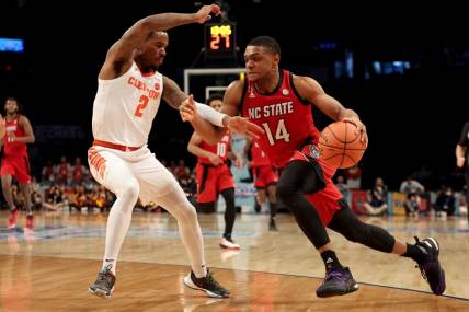 Mar 8, 2022; Brooklyn, NY, USA; North Carolina State Wolfpack guard Casey Morsell (14) drives to the basket against Clemson Tigers guard Al-Amir Dawes (2) during the second half at Barclays Center. Mandatory Credit: Brad Penner-USA TODAY Sports
