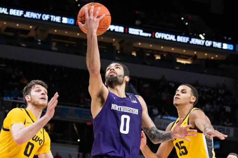 Mar 10, 2022; Indianapolis, IN, USA; Northwestern Wildcats guard Boo Buie (0) shoots the ball while Iowa Hawkeyes forward Filip Rebraca (0) defends in the second half at Gainbridge Fieldhouse. Mandatory Credit: Trevor Ruszkowski-USA TODAY Sports
