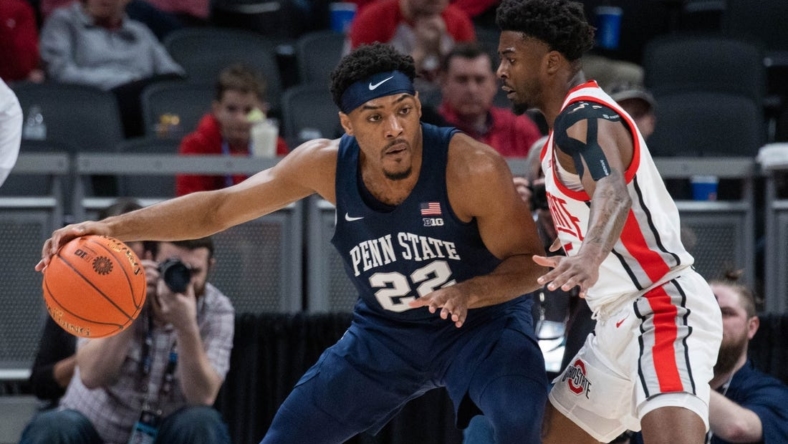 Mar 10, 2022; Indianapolis, IN, USA; Penn State Nittany Lions guard Jalen Pickett (22) dribbles the ball while Ohio State Buckeyes guard Jamari Wheeler (55) defends in the first half at Gainbridge Fieldhouse. Mandatory Credit: Trevor Ruszkowski-USA TODAY Sports