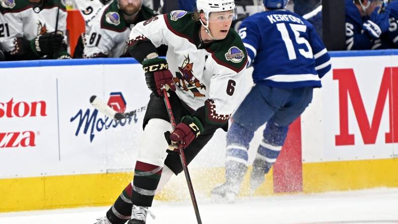 Mar 10, 2022; Toronto, Ontario, CAN; Arizona Coyotes defenseman Jakob Chychrun (6) carries the puck up ice against the Toronto Maple Leafs in the third period at Scotiabank Arena. Mandatory Credit: Dan Hamilton-USA TODAY Sports