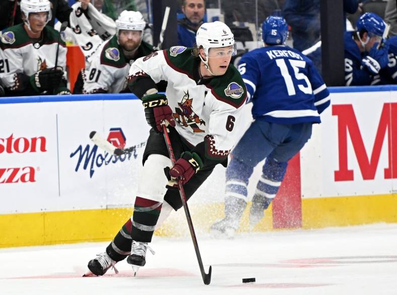 Mar 10, 2022; Toronto, Ontario, CAN; Arizona Coyotes defenseman Jakob Chychrun (6) carries the puck up ice against the Toronto Maple Leafs in the third period at Scotiabank Arena. Mandatory Credit: Dan Hamilton-USA TODAY Sports