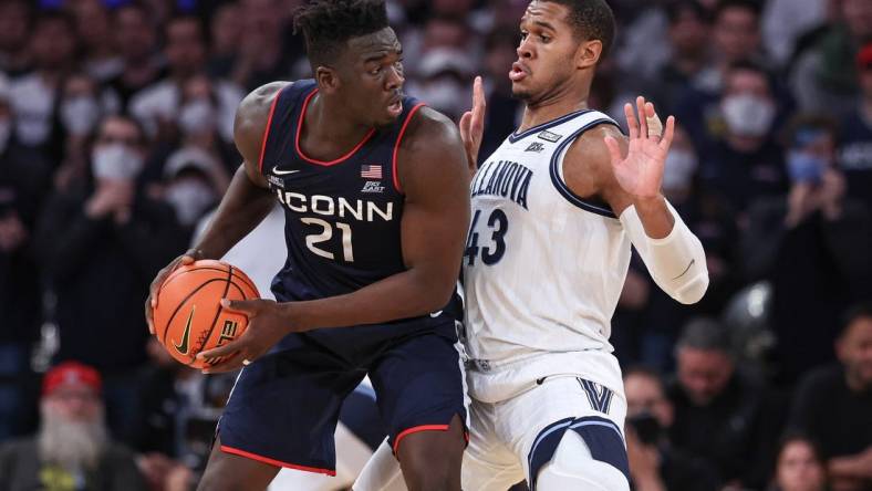 Mar 11, 2022; New York, NY, USA; Connecticut Huskies forward Adama Sanogo (21) controls the ball against Villanova Wildcats forward Eric Dixon (43) during the second half at Madison Square Garden. Mandatory Credit: Vincent Carchietta-USA TODAY Sports