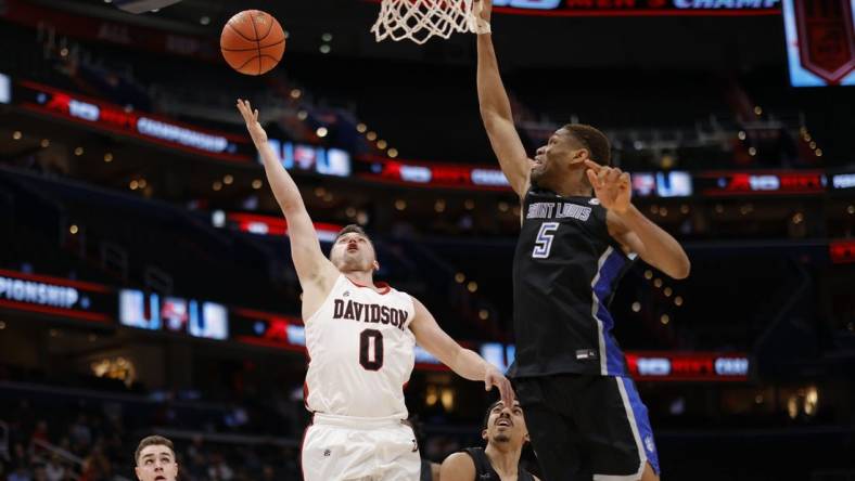 Mar 12, 2022; Washington, D.C., USA; Davidson Wildcats guard Foster Loyer (0) shoots the ball as Saint Louis Billikens forward Francis Okoro (5) defends in the first half at Capital One Arena. Mandatory Credit: Geoff Burke-USA TODAY Sports