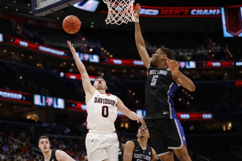Mar 12, 2022; Washington, D.C., USA; Davidson Wildcats guard Foster Loyer (0) shoots the ball as Saint Louis Billikens forward Francis Okoro (5) defends in the first half at Capital One Arena. Mandatory Credit: Geoff Burke-USA TODAY Sports