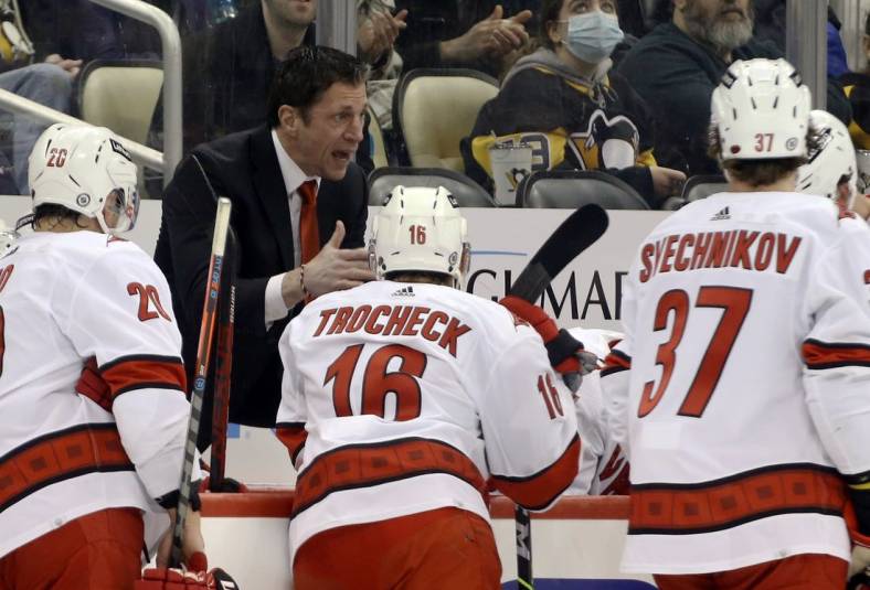 Mar 13, 2022; Pittsburgh, Pennsylvania, USA;  Carolina Hurricanes head coach Rod Brind'Amour (rear left) talks to his team during a time-out against the Pittsburgh Penguins in the third period at PPG Paints Arena. The Penguins won 4-2. Mandatory Credit: Charles LeClaire-USA TODAY Sports