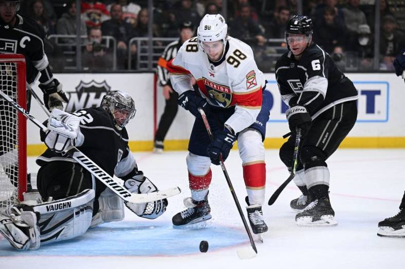 Mar 13, 2022; Los Angeles, California, USA; Florida Panthers center Maxim Mamin (98) goes for a rebound against Los Angeles Kings goaltender Jonathan Quick (32) during the third period at Crypto.com Arena. Mandatory Credit: Orlando Ramirez-USA TODAY Sports
