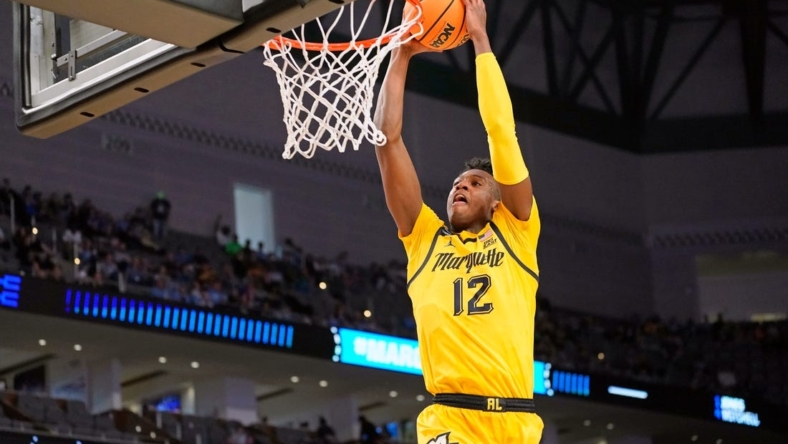 Mar 17, 2022; Fort Worth, TX, USA; Marquette Golden Eagles forward Olivier-Maxence Prosper (12) shoots the ball against the North Carolina Tar Heels during the second half during the first round of the 2022 NCAA Tournament at Dickies Arena. Mandatory Credit: Chris Jones-USA TODAY Sports