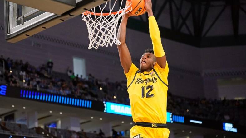 Mar 17, 2022; Fort Worth, TX, USA; Marquette Golden Eagles forward Olivier-Maxence Prosper (12) shoots the ball against the North Carolina Tar Heels during the second half during the first round of the 2022 NCAA Tournament at Dickies Arena. Mandatory Credit: Chris Jones-USA TODAY Sports