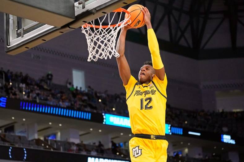 Mar 17, 2022; Fort Worth, TX, USA; Marquette Golden Eagles forward Olivier-Maxence Prosper (12) shoots the ball against the North Carolina Tar Heels during the second half during the first round of the 2022 NCAA Tournament at Dickies Arena. Mandatory Credit: Chris Jones-USA TODAY Sports