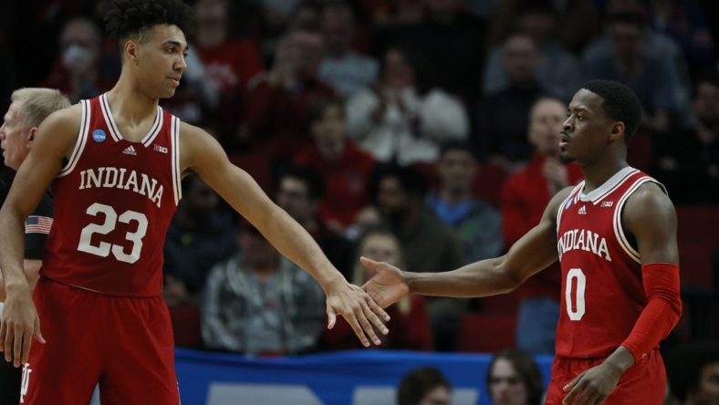 Mar 17, 2022; Portland, OR, USA; Indiana Hoosiers forward Trayce Jackson-Davis (23) and guard Xavier Johnson (0) high-five against the Saint Mary's Gaels during the first half during the first round of the 2022 NCAA Tournament at Moda Center. Mandatory Credit: Soobum Im-USA TODAY Sports