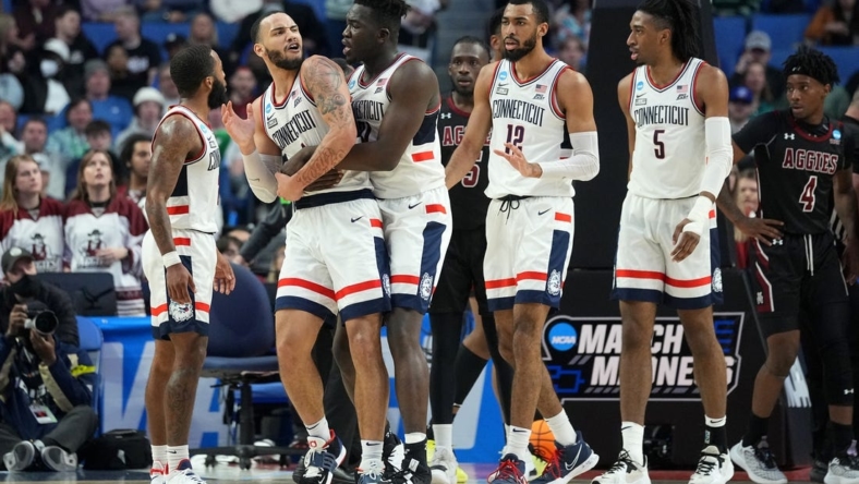 Mar 17, 2022; Buffalo, NY, USA; Connecticut Huskies guard Tyrese Martin (4), forward Adama Sanogo (21), forward Tyler Polley (12) and forward Isaiah Whaley (5) after a play in the second half against the New Mexico State Aggies during the first round of the 2022 NCAA Tournament at KeyBank Center. Mandatory Credit: Gregory Fisher-USA TODAY Sports