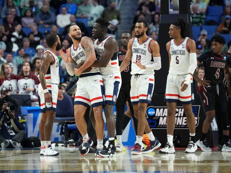 Mar 17, 2022; Buffalo, NY, USA; Connecticut Huskies guard Tyrese Martin (4), forward Adama Sanogo (21), forward Tyler Polley (12) and forward Isaiah Whaley (5) after a play in the second half against the New Mexico State Aggies during the first round of the 2022 NCAA Tournament at KeyBank Center. Mandatory Credit: Gregory Fisher-USA TODAY Sports