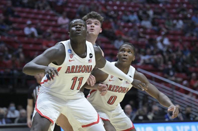 Mar 18, 2022; San Diego, CA, USA; Arizona Wildcats center Oumar Ballo (11) and guard Bennedict Mathurin (0) box out Wright State Raiders forward Grant Basile (00) during the first half during the first round of the 2022 NCAA Tournament at Viejas Arena. Mandatory Credit: Orlando Ramirez-USA TODAY Sports