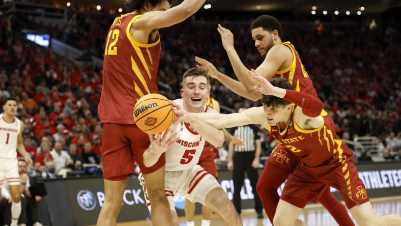 Mar 20, 2022; Milwaukee, WI, USA; Wisconsin Badgers forward Tyler Wahl (5) tries to gain control of the ball against Iowa State Cyclones forward Robert Jones (12) and Iowa State Cyclones guard Caleb Grill (2) during the second half in the second round of the 2022 NCAA Tournament at Fiserv Forum. Mandatory Credit: Jeff Hanisch-USA TODAY Sports