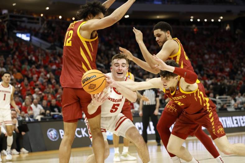 Mar 20, 2022; Milwaukee, WI, USA; Wisconsin Badgers forward Tyler Wahl (5) tries to gain control of the ball against Iowa State Cyclones forward Robert Jones (12) and Iowa State Cyclones guard Caleb Grill (2) during the second half in the second round of the 2022 NCAA Tournament at Fiserv Forum. Mandatory Credit: Jeff Hanisch-USA TODAY Sports
