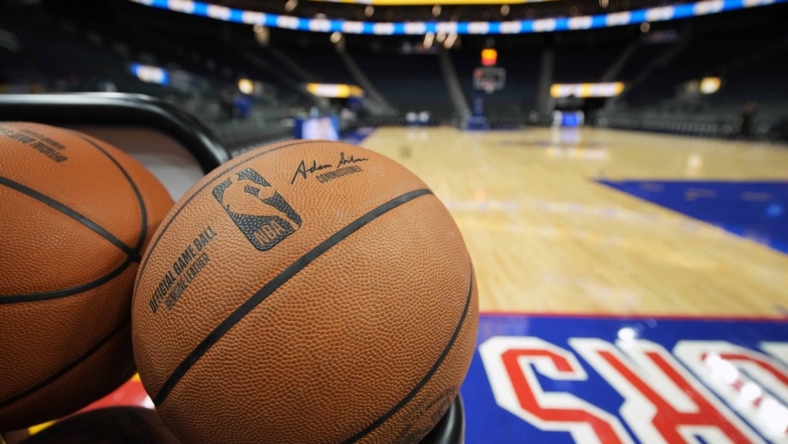 Mar 12, 2022; San Francisco, California, USA; A rack of basketballs sit on the baseline before the game between the Golden State Warriors and the Milwaukee Bucks at Chase Center. Mandatory Credit: Darren Yamashita-USA TODAY Sports