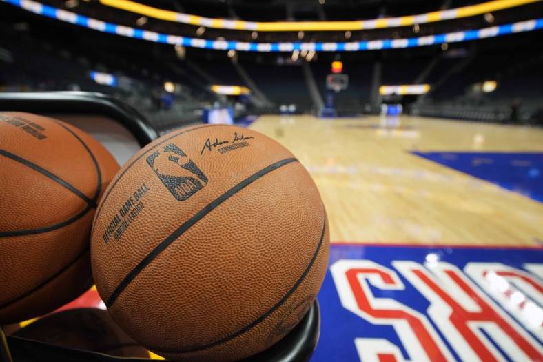 Mar 12, 2022; San Francisco, California, USA; A rack of basketballs sit on the baseline before the game between the Golden State Warriors and the Milwaukee Bucks at Chase Center. Mandatory Credit: Darren Yamashita-USA TODAY Sports