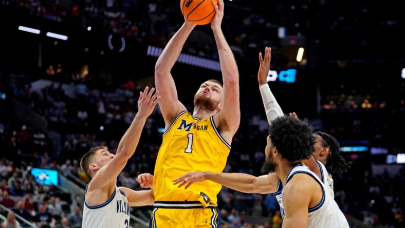 Mar 24, 2022; San Antonio, TX, USA; Michigan Wolverines center Hunter Dickinson (1) shoots the ball against Villanova Wildcats guard Collin Gillespie (2) in the semifinals of the South regional of the men's college basketball NCAA Tournament at AT&T Center. Mandatory Credit: Daniel Dunn-USA TODAY Sports