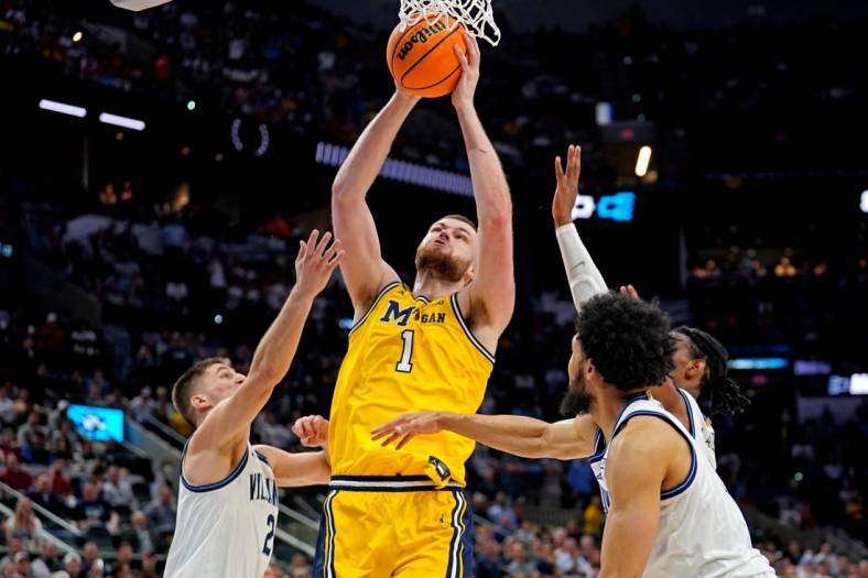 Mar 24, 2022; San Antonio, TX, USA; Michigan Wolverines center Hunter Dickinson (1) shoots the ball against Villanova Wildcats guard Collin Gillespie (2) in the semifinals of the South regional of the men's college basketball NCAA Tournament at AT&T Center. Mandatory Credit: Daniel Dunn-USA TODAY Sports
