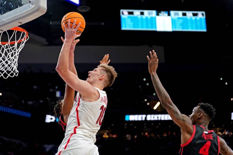 Mar 24, 2022; San Antonio, TX, USA; Arizona Wildcats forward Azuolas Tubelis (10) shoots the ball against Houston Cougars guard Taze Moore (4) during the second half in the semifinals of the South regional of the men's college basketball NCAA Tournament at AT&T Center. Mandatory Credit: Daniel Dunn-USA TODAY Sports
