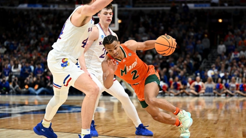Mar 27, 2022; Chicago, IL, USA; Miami Hurricanes guard Isaiah Wong (2) drives against Kansas Jayhawks forward Mitch Lightfoot (44) during the second half in the finals of the Midwest regional of the men's college basketball NCAA Tournament at United Center. Mandatory Credit: Jamie Sabau-USA TODAY Sports