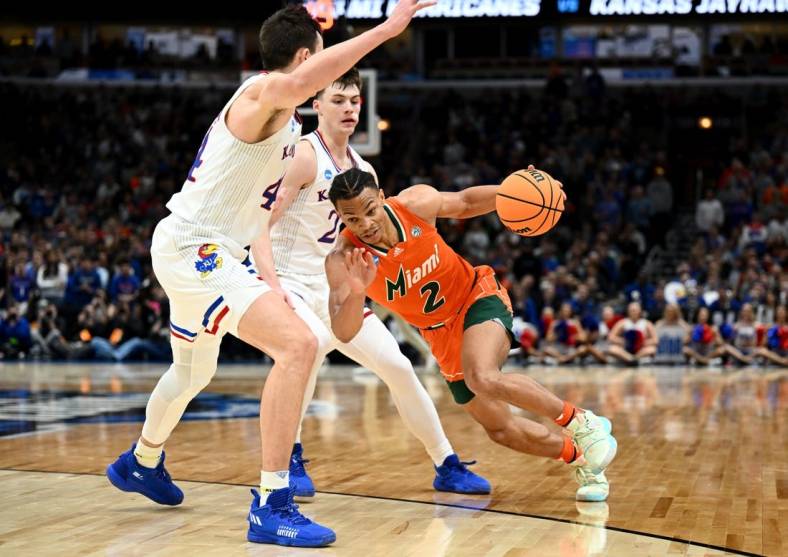 Mar 27, 2022; Chicago, IL, USA; Miami Hurricanes guard Isaiah Wong (2) drives against Kansas Jayhawks forward Mitch Lightfoot (44) during the second half in the finals of the Midwest regional of the men's college basketball NCAA Tournament at United Center. Mandatory Credit: Jamie Sabau-USA TODAY Sports