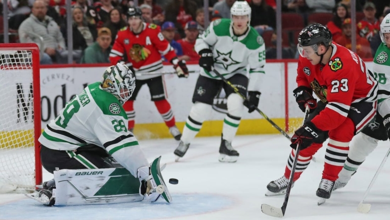 Apr 10, 2022; Chicago, Illinois, USA;Dallas Stars goaltender Jake Oettinger (29) makes a save on a shot from Chicago Blackhawks center Philipp Kurashev (23)  during the third period at the United Center. Mandatory Credit: Dennis Wierzbicki-USA TODAY Sports