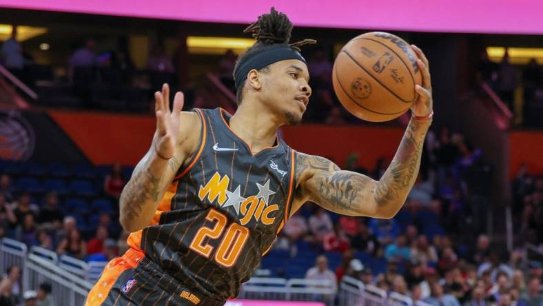 Apr 10, 2022; Orlando, Florida, USA; Orlando Magic guard Markelle Fultz (20) grabs the rebound against the Miami Heat during the first quarter at Amway Center. Mandatory Credit: Mike Watters-USA TODAY Sports