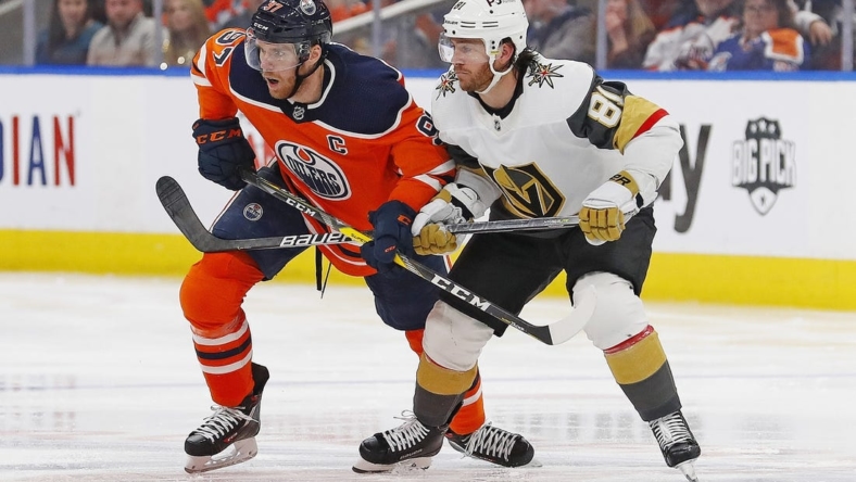 Apr 16, 2022; Edmonton, Alberta, CAN; Edmonton Oilers forward Connor McDavid (97) and Vegas Golden Knights forward Jonathan Marchessault (81) look for a loose puck p3/ at Rogers Place. Mandatory Credit: Perry Nelson-USA TODAY Sports