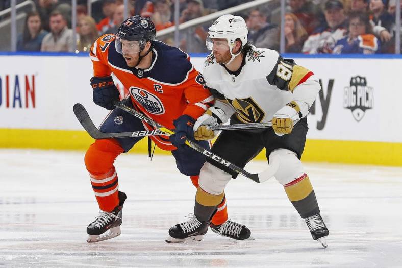 Apr 16, 2022; Edmonton, Alberta, CAN; Edmonton Oilers forward Connor McDavid (97) and Vegas Golden Knights forward Jonathan Marchessault (81) look for a loose puck p3/ at Rogers Place. Mandatory Credit: Perry Nelson-USA TODAY Sports