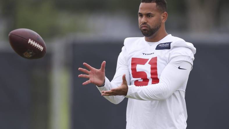 May 24, 2022; Houston, Texas, USA; Houston Texans line backer Kamu Grugier-Hill (51) plays catch with another teammate during organized team activities at the Houston Texans practice field. Mandatory Credit: Thomas Shea-USA TODAY Sports