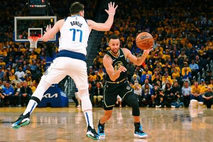 May 26, 2022; San Francisco, California, USA; Golden State Warriors guard Stephen Curry (30) passes the ball against Dallas Mavericks guard Luka Doncic (77) during the second half of game five of the 2022 western conference finals at Chase Center. Mandatory Credit: Kelley L Cox-USA TODAY Sports