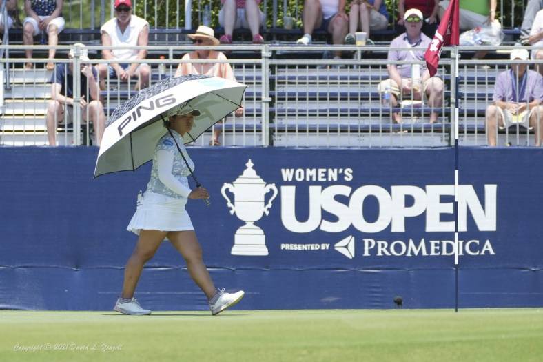 Jun 2, 2022; Southern Pines, North Carolina, USA; Ai Suzuki protects herself from the heat with an umbrella during the first round of the U.S. Women's Open. Mandatory Credit: David Yeazell-USA TODAY Sports